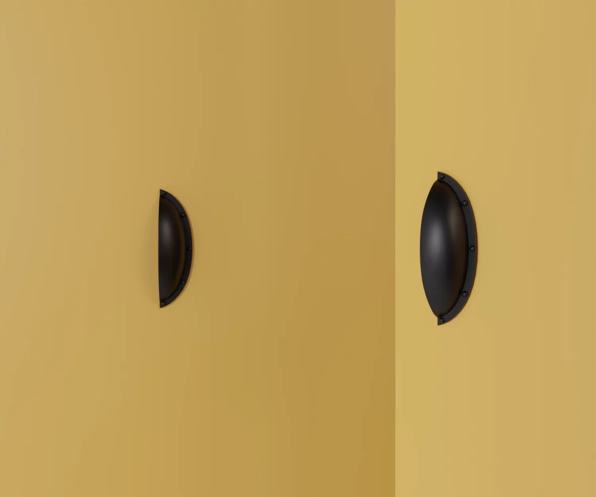 Zwei mattschwarze Zink-Möbelgriffe vom Typ HA-ZI-11031 vor gelbem Hintergrund: links in Frontalansicht, rechts in Dreiviertelansicht.