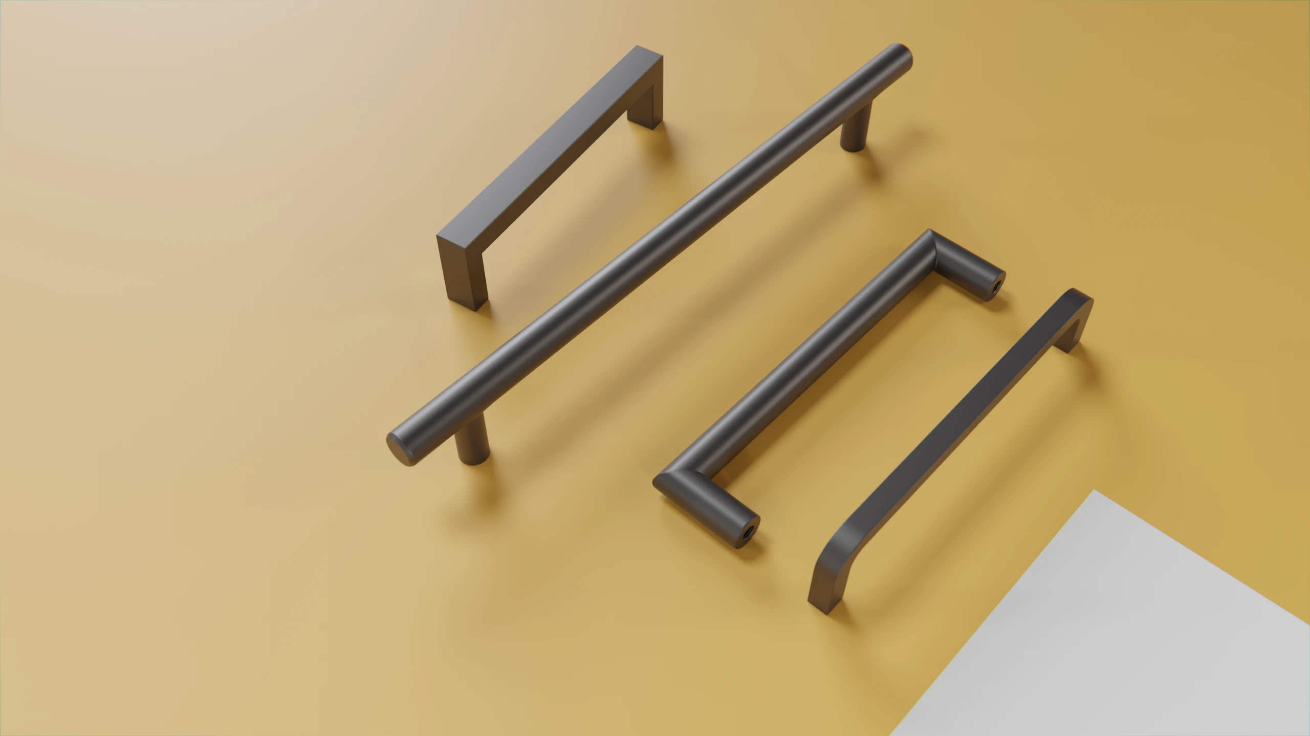 Eine Ansammlung von 4 Möbelgriffen aus Edelstahl auf gelben Hintergrund.